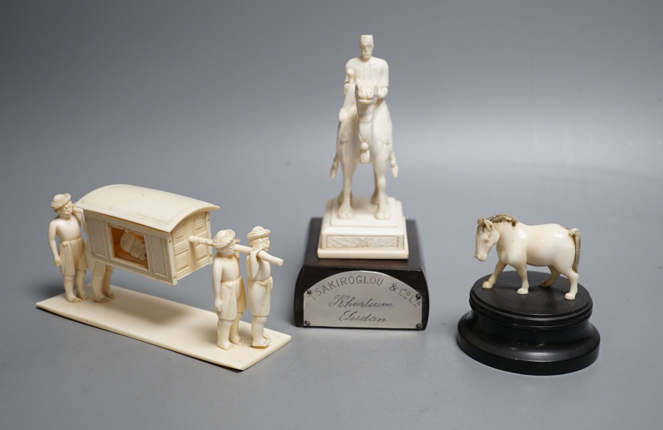 An Indian ivory sedan chair, an ivory horse and an ivory man on camel (General Gordon) with white metal plaque, 19th/early 20th century , Ivory carving of a man on a camel 14.5cms high.